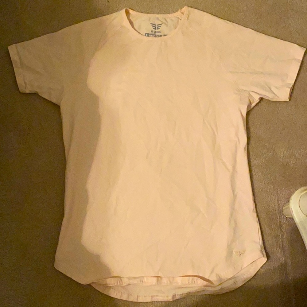 A peach colored, edge t-shirt.